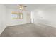 Bright living area featuring plush carpet, fan, and door to balcony at 1103 Tektite Ave, Henderson, NV 89011