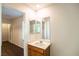 Bright vanity and sink in the bathroom area, with storage, mirror and hallway access at 11044 Camden Bay St, Las Vegas, NV 89179