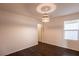 Comfortable bedroom with wood floors, natural lighting, and a modern light fixture at 11044 Camden Bay St, Las Vegas, NV 89179