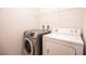 Modern laundry room with front load washer, dryer and wire shelving at 11044 Camden Bay St, Las Vegas, NV 89179