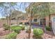 A landscaped backyard with brick pavers, a small patch of green grass and manicured shrubs at 1554 Ward Frontier Ln, Henderson, NV 89002