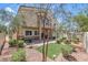 A landscaped backyard featuring a covered patio and lush greenery and brick pavers at 1554 Ward Frontier Ln, Henderson, NV 89002