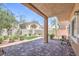 Enjoy a covered patio and beautiful backyard with lush landscaping and brick pavers at 1554 Ward Frontier Ln, Henderson, NV 89002