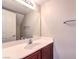 Bathroom featuring a sink with dark wood cabinets, a large mirror, and ample lighting at 1554 Ward Frontier Ln, Henderson, NV 89002