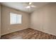 Neutral bedroom with natural light, wood-look floors, and a ceiling fan at 1554 Ward Frontier Ln, Henderson, NV 89002