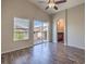 Bedroom boasts plank flooring, a ceiling fan, and a sliding glass door to a balcony at 1554 Ward Frontier Ln, Henderson, NV 89002
