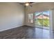 Bedroom featuring sleek laminate flooring, a modern ceiling fan, and a sliding glass door at 1554 Ward Frontier Ln, Henderson, NV 89002
