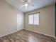 This bedroom boasts wood-look floors, a ceiling fan, and a window that provides natural light at 1554 Ward Frontier Ln, Henderson, NV 89002