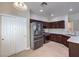 Modern kitchen with stainless steel appliances and dark wood cabinetry at 1554 Ward Frontier Ln, Henderson, NV 89002