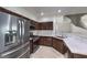 Modern kitchen with stainless steel appliances and dark wood cabinetry at 1554 Ward Frontier Ln, Henderson, NV 89002