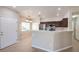 Open-concept kitchen with stainless steel appliances and bar at 1554 Ward Frontier Ln, Henderson, NV 89002