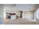 Open-concept living room with tile flooring, fireplace and a glimpse of the kitchen at 1554 Ward Frontier Ln, Henderson, NV 89002