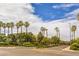 Scenic street view with palm trees, manicured landscaping, and clear skies in a desirable neighborhood at 1554 Ward Frontier Ln, Henderson, NV 89002