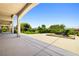Covered back patio with a well-maintained, landscaped yard featuring a fire pit, mature trees and garden at 2164 Noonday Ct, Henderson, NV 89052