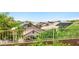 Backyard view with a black iron fence featuring views of adjacent homes and desert landscaping at 2164 Noonday Ct, Henderson, NV 89052