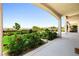 Charming backyard view from a covered patio, showcasing roses, lush greenery, and a neatly landscaped garden at 2164 Noonday Ct, Henderson, NV 89052