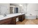 Bright bathroom features a soaking tub and dual vanity sinks with plenty of cabinet space at 2164 Noonday Ct, Henderson, NV 89052