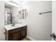 Bathroom with vanity, framed mirror and shower behind glass door at 2164 Noonday Ct, Henderson, NV 89052