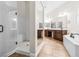 Bright bathroom features a shower, soaking tub, and dual vanity sinks with plenty of cabinet space at 2164 Noonday Ct, Henderson, NV 89052