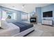 A beautifully staged bedroom with blue walls, a fireplace, and bay windows at 2164 Noonday Ct, Henderson, NV 89052