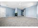 Large bedroom with neutral carpet, fireplace, ceiling fan, and blue walls at 2164 Noonday Ct, Henderson, NV 89052