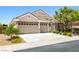 Charming single-story home featuring a three-car garage and manicured landscaping at 2164 Noonday Ct, Henderson, NV 89052