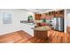 Bright open kitchen featuring stainless appliances, custom cabinets, and breakfast bar at 2164 Noonday Ct, Henderson, NV 89052