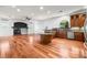 Spacious living area with a fireplace, hardwood floors, and a large kitchen island at 2164 Noonday Ct, Henderson, NV 89052