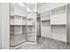 Spacious walk-in closet with mirrored wall, carpet and custom shelving for optimal storage and organization at 2164 Noonday Ct, Henderson, NV 89052