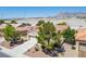 Scenic aerial view of a single-story residence with lush landscaping, a red-tiled roof, and picturesque mountains at 2315 Sun Cliffs St, Las Vegas, NV 89134
