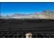 Scenic aerial shot of desert homes with tile roofs with highway and mountains beyond at 2315 Sun Cliffs St, Las Vegas, NV 89134