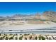 Panoramic view showcases homes with red roofs, desert landscapes, and the majestic mountains in the background at 2315 Sun Cliffs St, Las Vegas, NV 89134