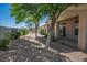 Serene backyard with gravel landscaping, mature trees, and a covered patio area at 2315 Sun Cliffs St, Las Vegas, NV 89134