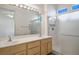 Bathroom featuring double sinks, large mirror, and walk-in shower with glass door at 2315 Sun Cliffs St, Las Vegas, NV 89134