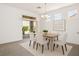 Dining area showcasing backyard view, a dining table set for six, and an art piece on the wall at 2315 Sun Cliffs St, Las Vegas, NV 89134