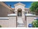 Charming single story home with stucco exterior, tiled roof, arched entry and a secured gate at 2315 Sun Cliffs St, Las Vegas, NV 89134