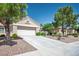 Well-maintained single-story home with lush landscaping, an attached garage, and a long driveway at 2315 Sun Cliffs St, Las Vegas, NV 89134
