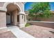 Charming front porch with brick flooring and stucco columns offers a welcoming entrance to the home at 2315 Sun Cliffs St, Las Vegas, NV 89134
