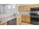 Well-equipped kitchen with light wood cabinets, stainless steel appliances, and a tiled backsplash at 2315 Sun Cliffs St, Las Vegas, NV 89134
