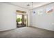 Bright living room with neutral carpet, sliding glass door, and chandelier lighting at 2315 Sun Cliffs St, Las Vegas, NV 89134