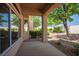 Covered patio area with lush landscaping and mature tree, perfect for outdoor relaxation and shade at 2315 Sun Cliffs St, Las Vegas, NV 89134