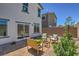 Cozy backyard seating area next to a home's windows and a desert landscaped private space at 2642 Begonia Falls Ave # 40, North Las Vegas, NV 89081