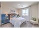 Cozy bedroom with a comfortable bed, stylish lamps, and a bright window view at 2642 Begonia Falls Ave # 40, North Las Vegas, NV 89081