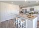 Modern kitchen with stainless steel appliances, white cabinets, grey countertop and barstool seating at island at 2642 Begonia Falls Ave # 40, North Las Vegas, NV 89081