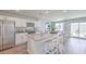 Bright kitchen featuring stainless steel appliances, kitchen island with bar stool seating and patio access at 2642 Begonia Falls Ave # 40, North Las Vegas, NV 89081