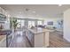 Open concept kitchen with stainless steel appliances, an island, dining area, and a view of the living room at 2642 Begonia Falls Ave # 40, North Las Vegas, NV 89081