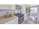Close up of a kitchen with stainless steel appliances, white cabinets, and an eat-in dining area at 2642 Begonia Falls Ave # 40, North Las Vegas, NV 89081