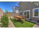 Well-maintained backyard featuring gravel landscaping, a small patch of turf, and a patio set for outdoor enjoyment at 2646 Begonia Falls Ave # 41, North Las Vegas, NV 89081