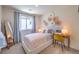 A well-decorated bedroom features a cozy bed, a modern desk, and plenty of natural light at 2646 Begonia Falls Ave # 41, North Las Vegas, NV 89081