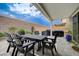 Covered patio area showcasing outdoor dining and grilling spaces with lush landscaping at 2651 Deep Canyon St, Henderson, NV 89044